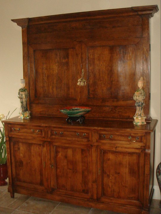 Custom-built cabinet in cherry to hide flat-screen TV with hand-wax finish to match bottom cabinet.